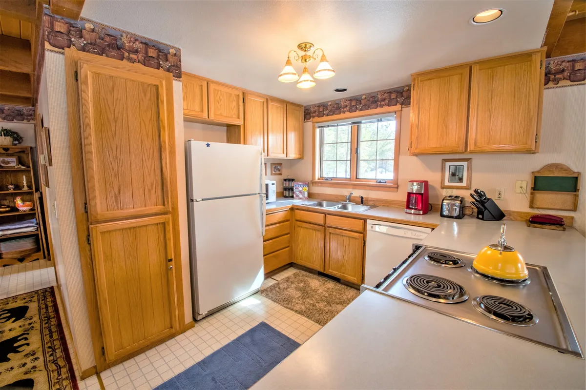 This image highlights the heart of the kitchen, featuring a prominent kitchen island bathed in natural light. Modern appliances and a well-organized workspace are visible, creating a welcoming environment for meal prep or baking. The mood is lively and inviting, suggesting family or group activities like baking cookies or sharing stories over breakfast.